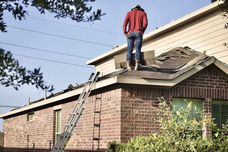 Professional roofer working on a residential roof in Oakridge Farms